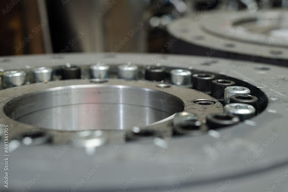 Macro shot of huge round detail or spare part for industrial or construction machine made up of stainless steel Macro shot of huge round detail or spare part for industrial or construction machine made up of stainless steel