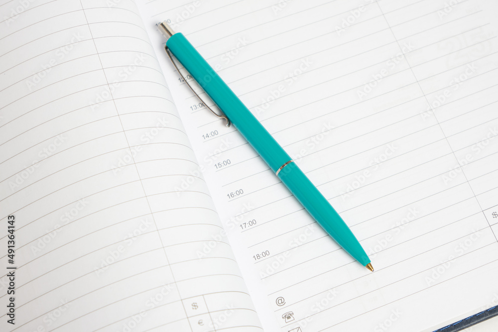 Green ballpoint pen background white sheets daily planner. Green ballpoint pen background white sheets daily planner.