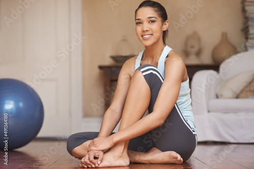 Healthy living. An attractive young woman working out at home.