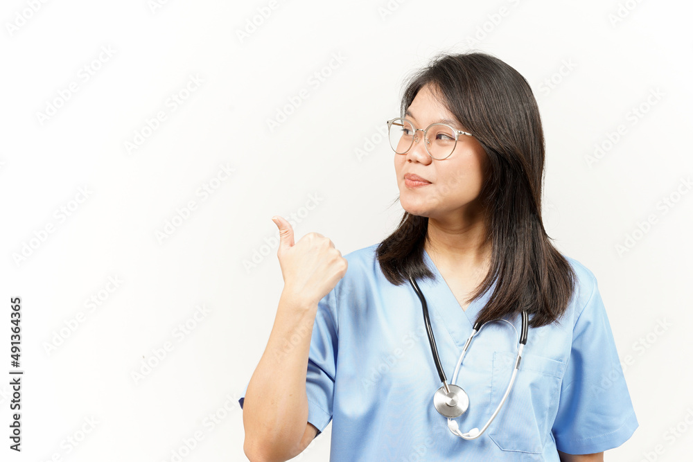 Showing and Pointing Product With Thumb Of Asian Young Doctor Isolated On White Background Showing and Pointing Product With Thumb Of Asian Young Doctor Isolated On White Background