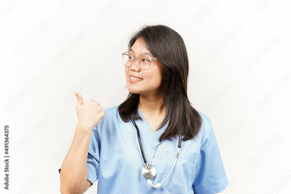 Showing and Pointing Product With Thumb Of Asian Young Doctor Isolated On White Background Showing and Pointing Product With Thumb Of Asian Young Doctor Isolated On White Background