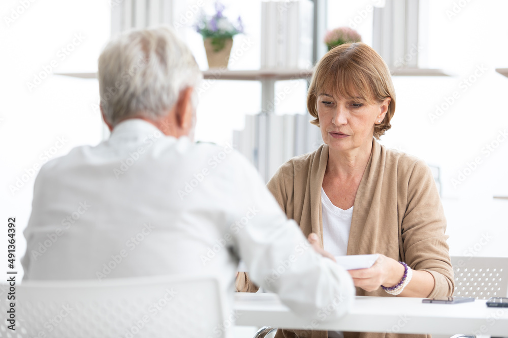 senior businesswoman or employer asking and talking about works to coworker senior businesswoman or employer asking and talking about works to coworker