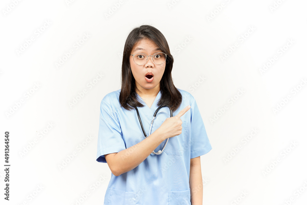 Showing Product and Pointing Side Of Asian Young Doctor Isolated On White Background Showing Product and Pointing Side Of Asian Young Doctor Isolated On White Background
