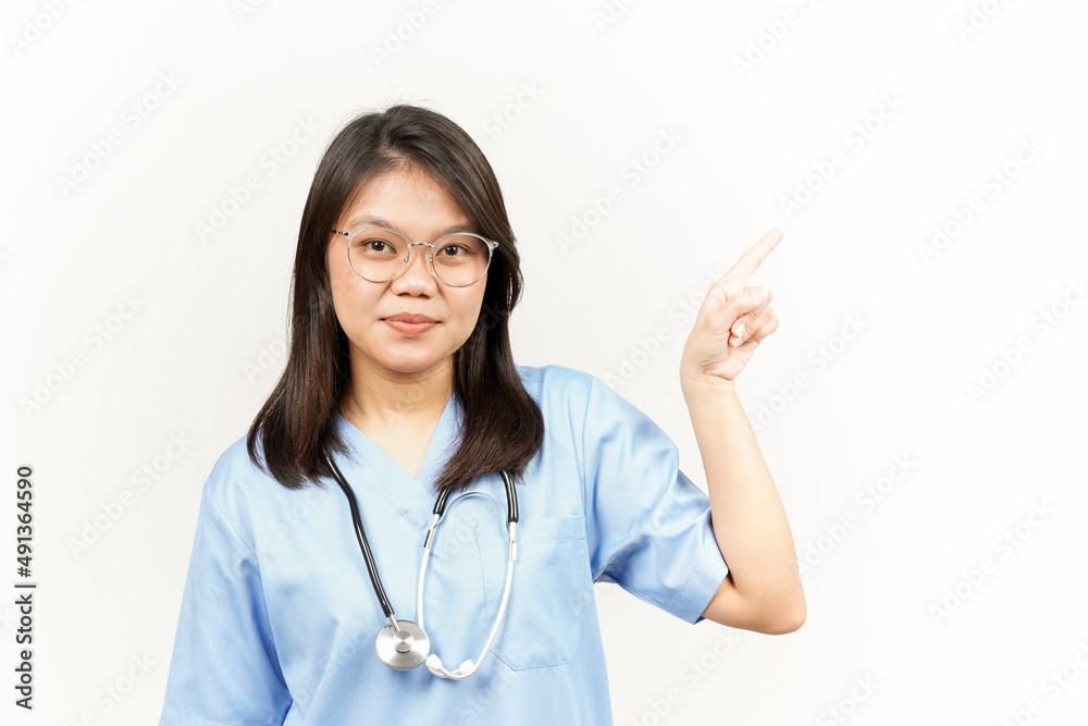 Showing Product and Pointing Side Of Asian Young Doctor Isolated On White Background Showing Product and Pointing Side Of Asian Young Doctor Isolated On White Background