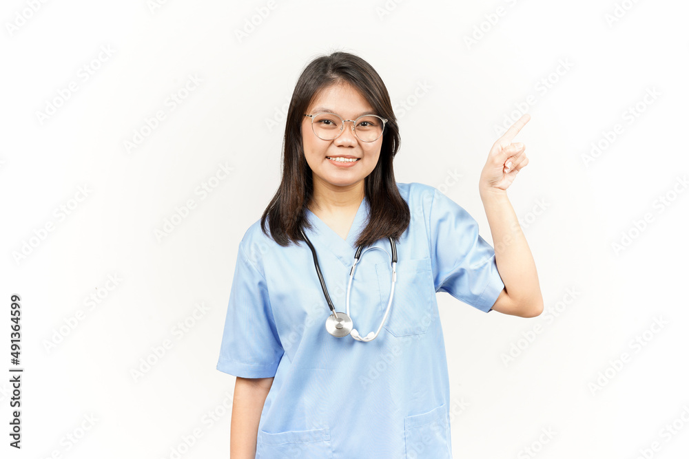 Showing Product and Pointing Side Of Asian Young Doctor Isolated On White Background Showing Product and Pointing Side Of Asian Young Doctor Isolated On White Background
