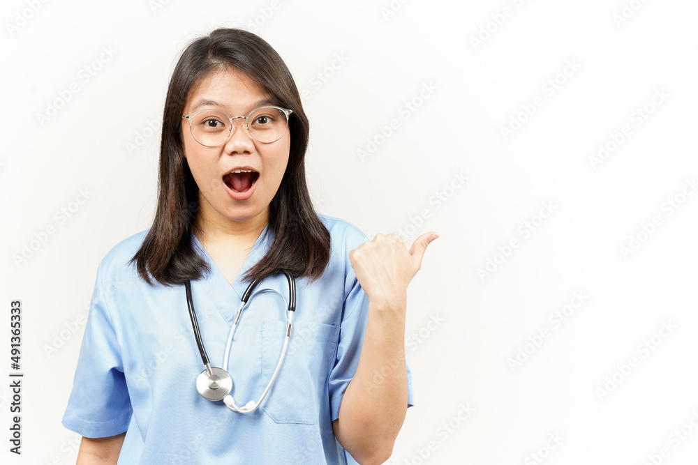 Showing and Pointing Product With Thumb Of Asian Young Doctor Isolated On White Background Showing and Pointing Product With Thumb Of Asian Young Doctor Isolated On White Background