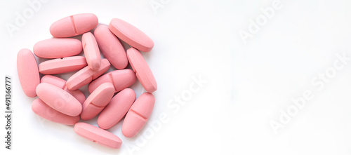 Banner of pink pills isolated on white background top view photo