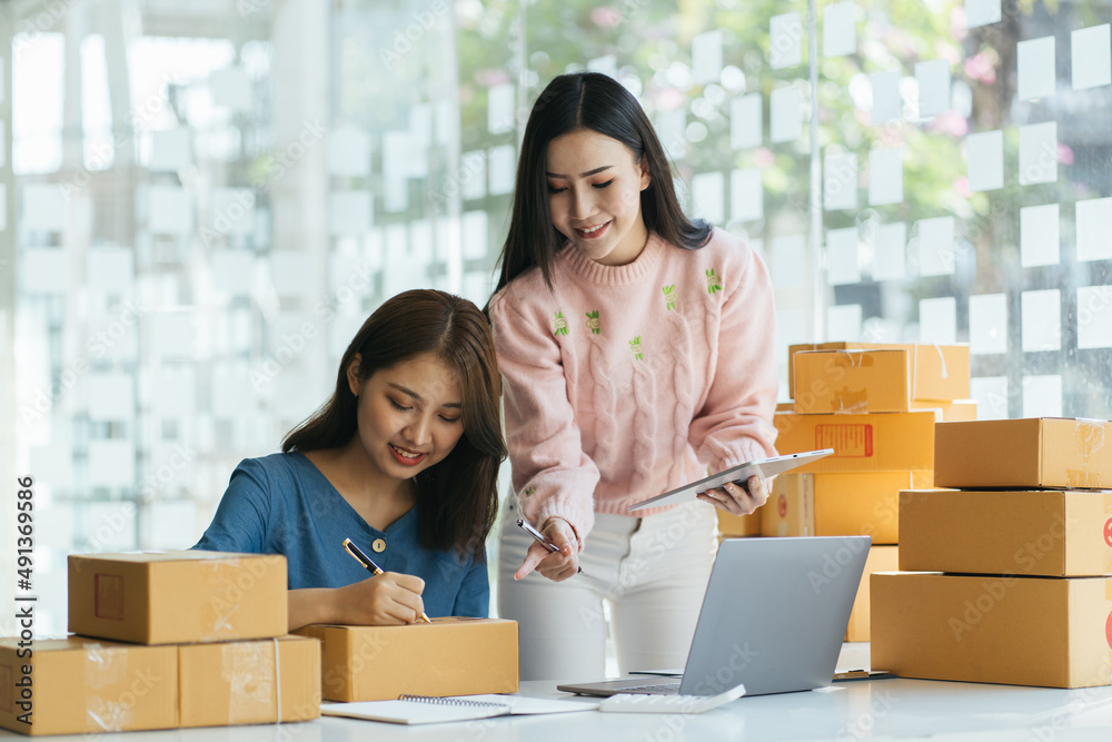 Two asian women with startup small business entrepreneur freelance working at home. checking product order. Online woman sellers working for e-business commerce. Shopping online, SME concept. Two asian women with startup small business entrepreneur freelance working at home. checking product order. Online woman sellers working for e-business commerce. Shopping online, SME concept.