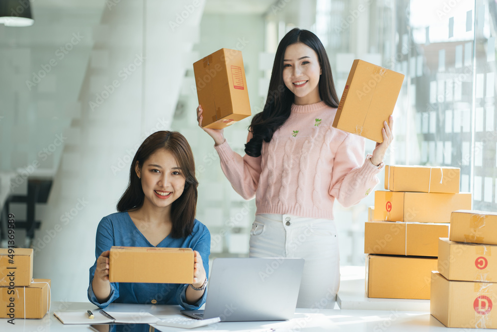 Two asian women with startup small business entrepreneur freelance working at home. checking product order. Online woman sellers working for e-business commerce. Shopping online, SME concept. Two asian women with startup small business entrepreneur freelance working at home. checking product order. Online woman sellers working for e-business commerce. Shopping online, SME concept.