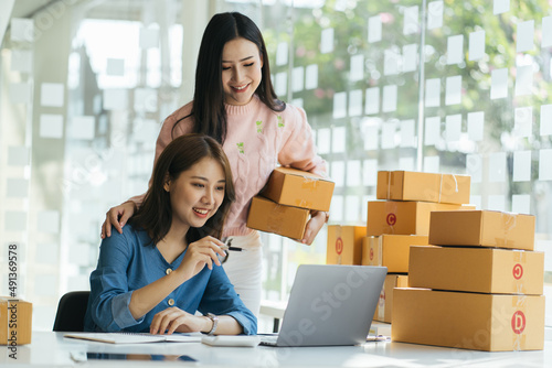 Two young Asian people startup small business entrepreneur SME distribution warehouse with parcel mail box. small owner home office. Online marketing and product packaging and delivery service © PaeGAG