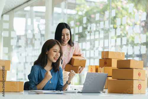 Two asian women with startup small business entrepreneur freelance working at home. checking product order. Online woman sellers working for e-business commerce. Shopping online, SME concept. © PaeGAG