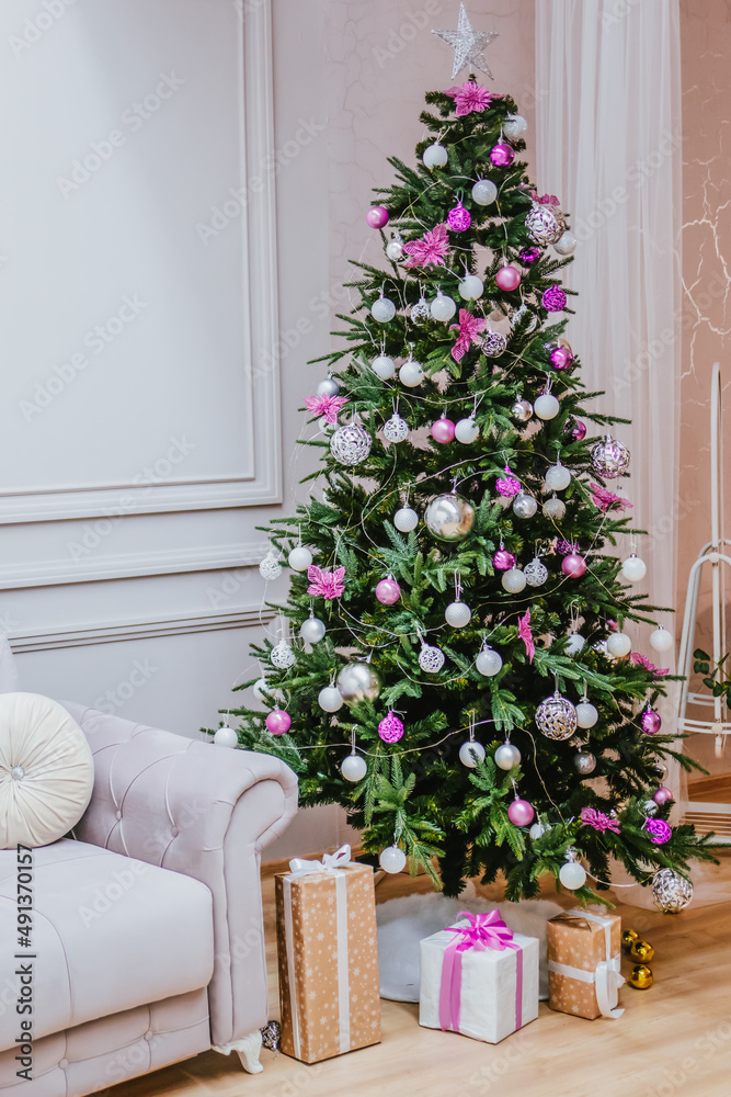 Christmas home decor. Christmas tree in purple tones with lanterns.