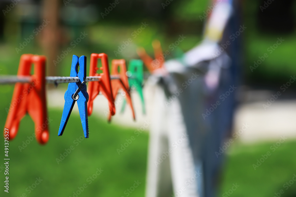 Clothespins on a clothesline in summer. Dry clothes outside. Clothes on a rope.