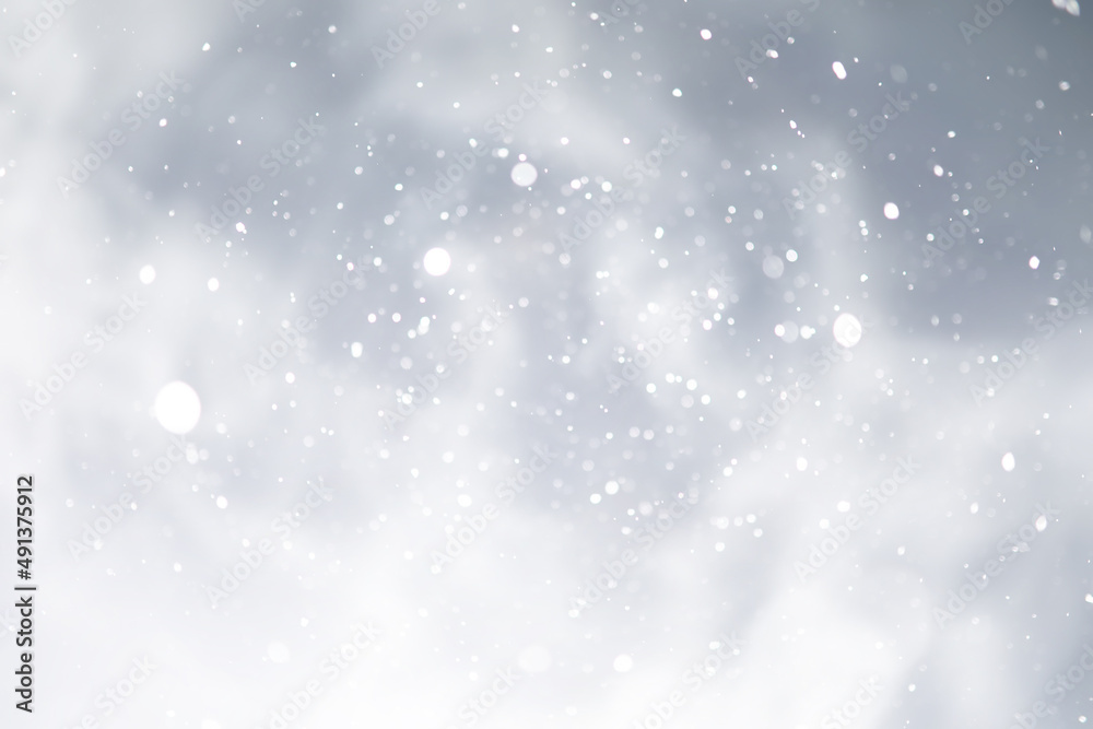 Fototapeta premium blue snowfall bokeh background, abstract snowflake background on blurred abstract blue