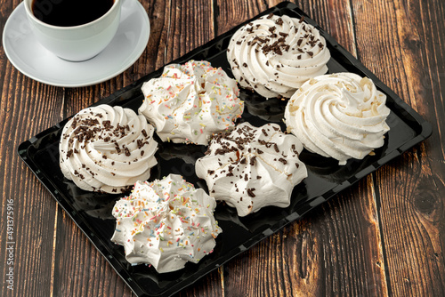 meringue cookies or beze cookies with candy and chocolate photo
