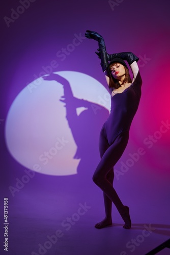 glamorous woman scene spotlight posing neon purple background unaltered