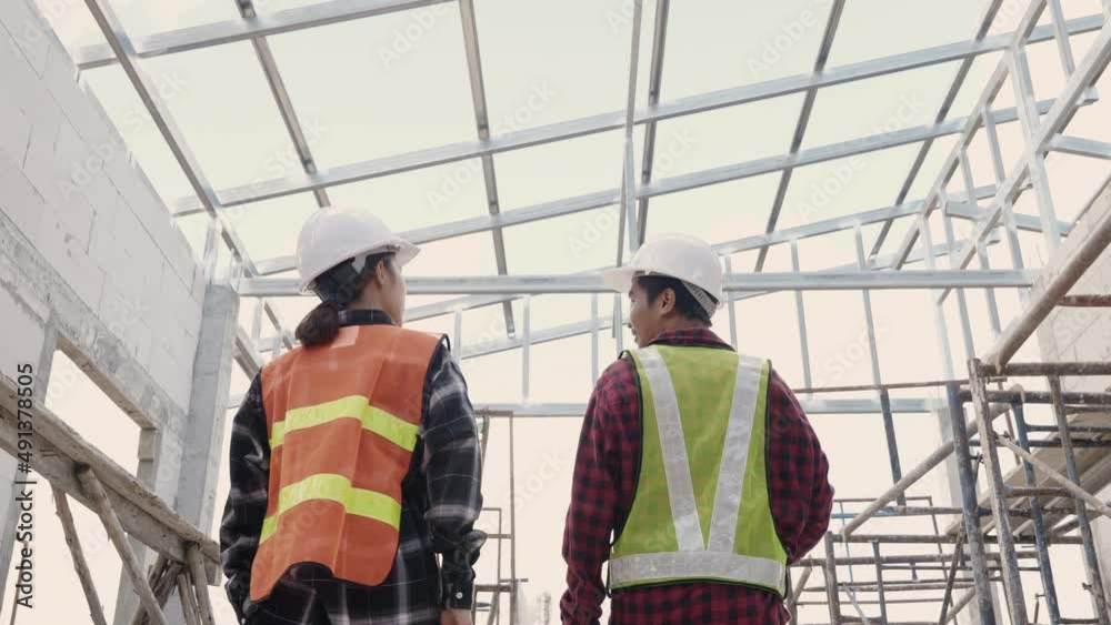 Asian engineer worker in protective helmet walking to checking Asian engineer worker in protective helmet walking to checking