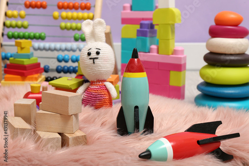Set of different toys on faux fur rug