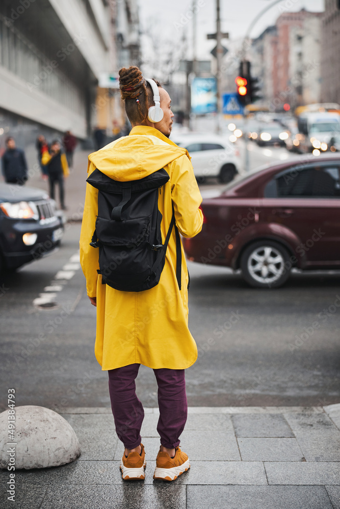 Fototapeta premium Young stylish man with headphones in city centre
