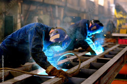 A welder works at a factory photo