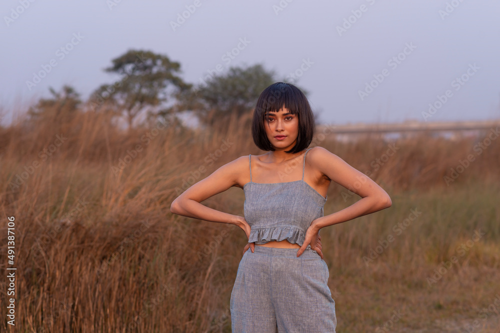 Beautiful Young Fashion model posing outdoor in casual garments Beautiful Young Fashion model posing outdoor in casual garments