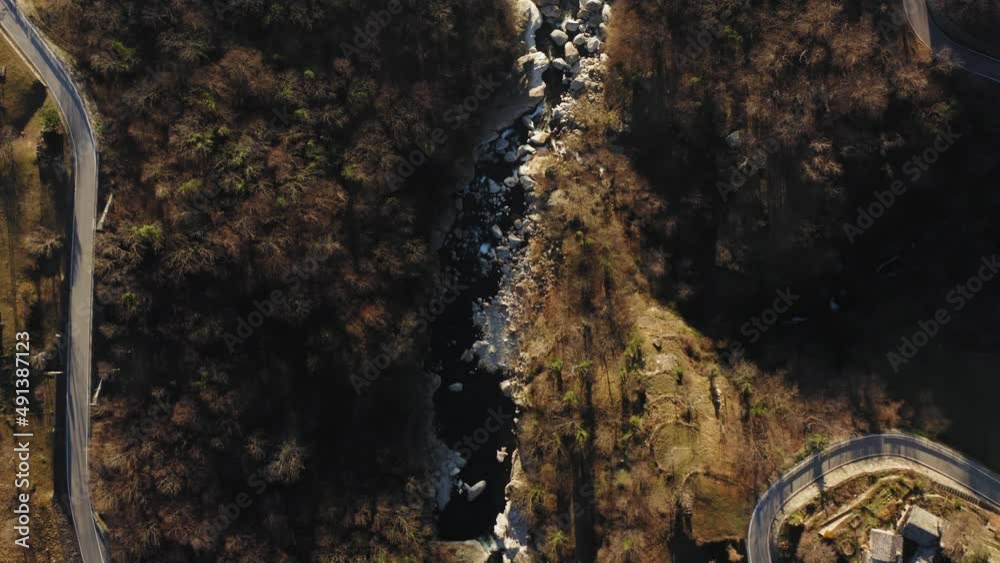 Aerial view mountain landscape, river crossing mountain, curved road overpass the river. Pine forest on both side. Aerial view mountain landscape, river crossing mountain, curved road overpass the river. Pine forest on both side.