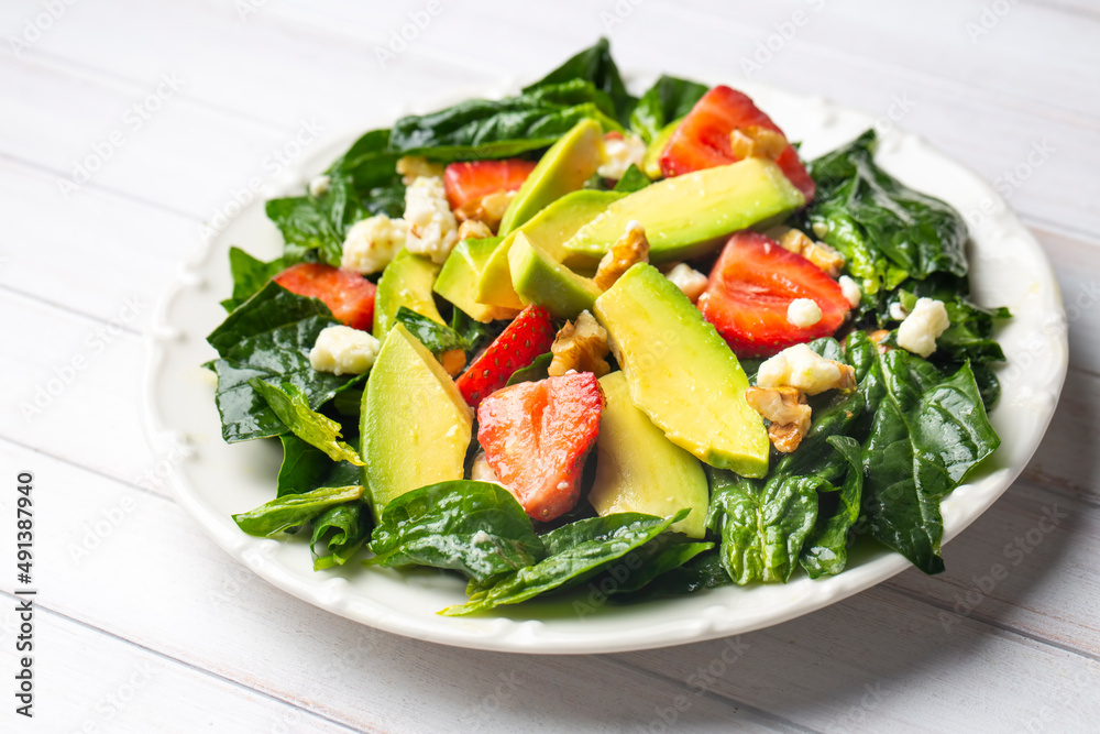 Healthy diet salad; Strawberry Spinach Salad with Avocado.