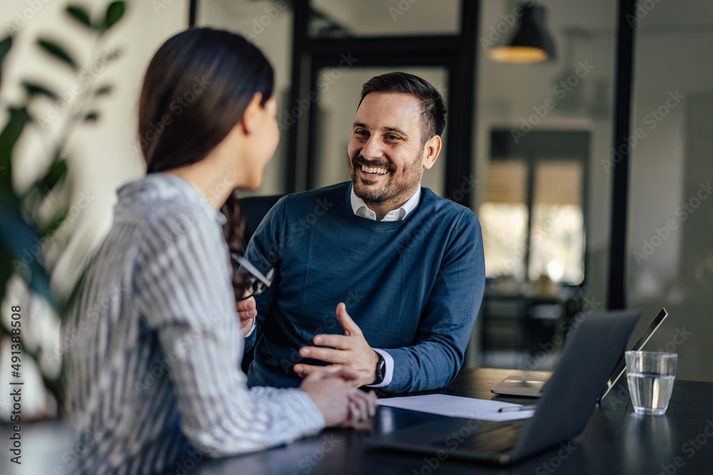 Smiling caucasian man, bonding with his coworker, having a conversation. Smiling caucasian man, bonding with his coworker, having a conversation.