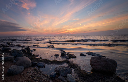 rocks in the sea at sunset © Martins