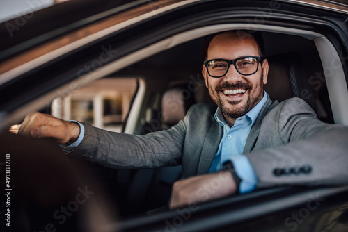 Fotografering Close up of a happy man ready to drive his new car for the first