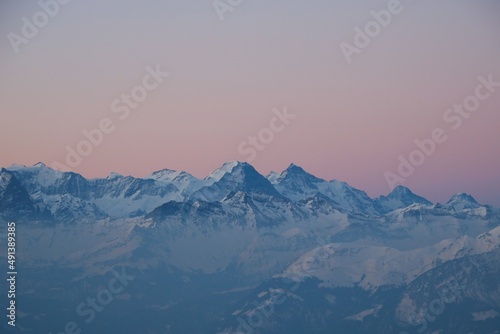 Pink sky over Eiger, Monch and Jungfrau. Sunrise scene in the Swiss Alps.
