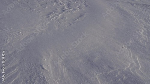 movement of snow particles on a white snow fancy cover, footprints in snow