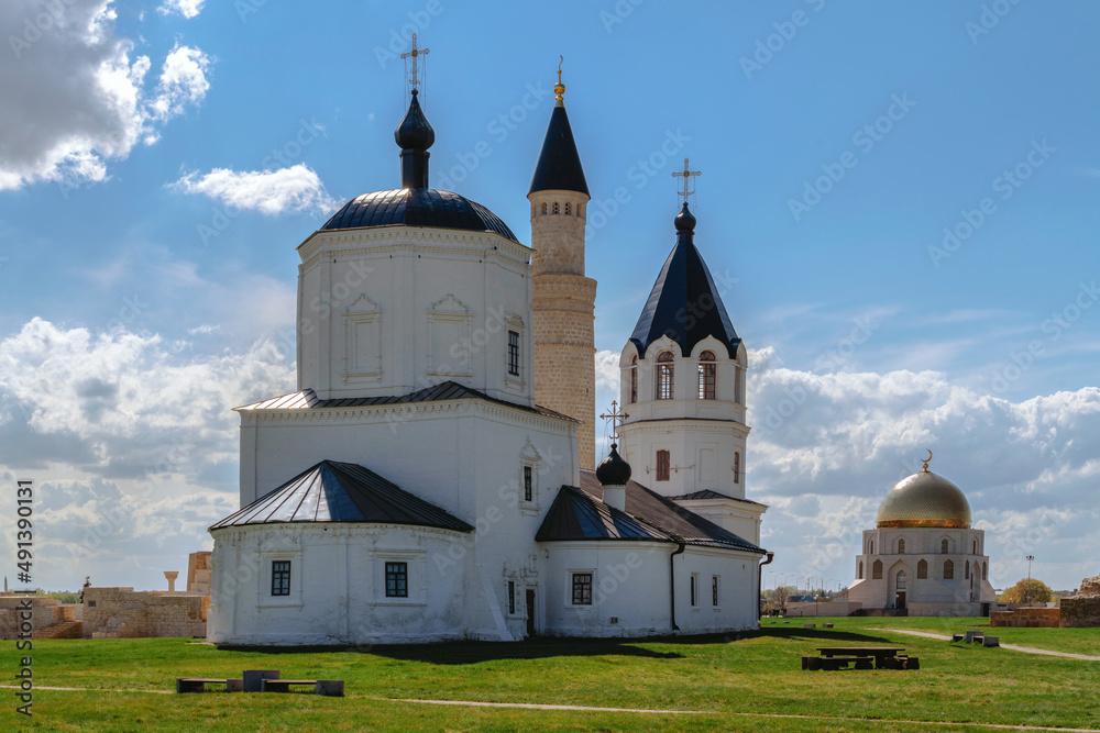 View of the Assumption Church, a large minaret, a memorial sign in honor of the official adoption of Islam by the Volga Bulgars and the Northern Mausoleum. Bolgar, Republic of Tatarstan, Russia