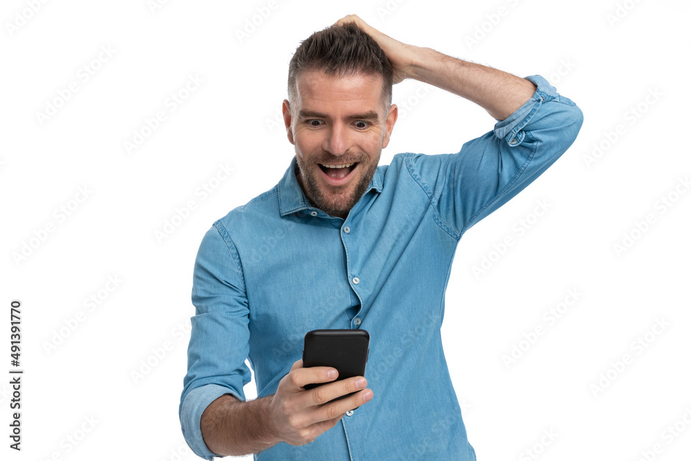 surprised grizzle haired man scratching head and reading messages surprised grizzle haired man scratching head and reading messages