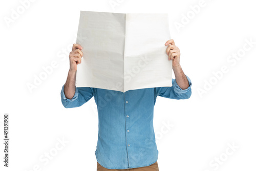 guy in denim shirt hiding behind newspaper