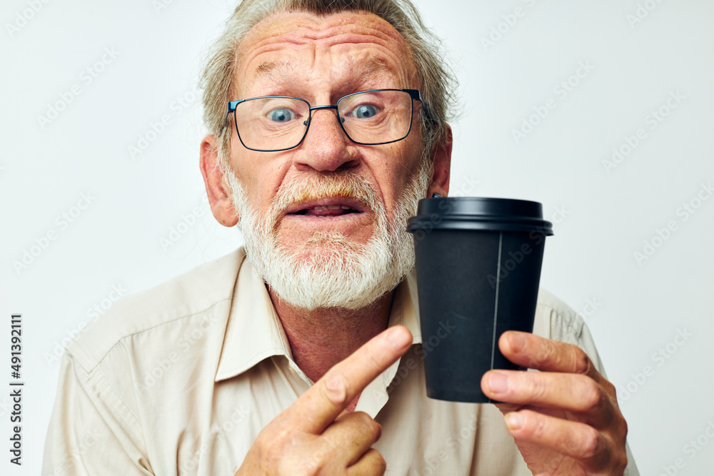 Senior grey-haired man in a shirt and glasses a black glass isolated background Senior grey-haired man in a shirt and glasses a black glass isolated background