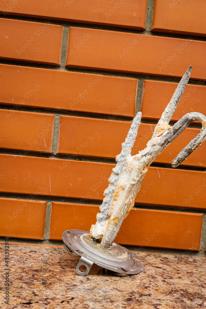 Water heater maintenance. Scum on electric heating element of water