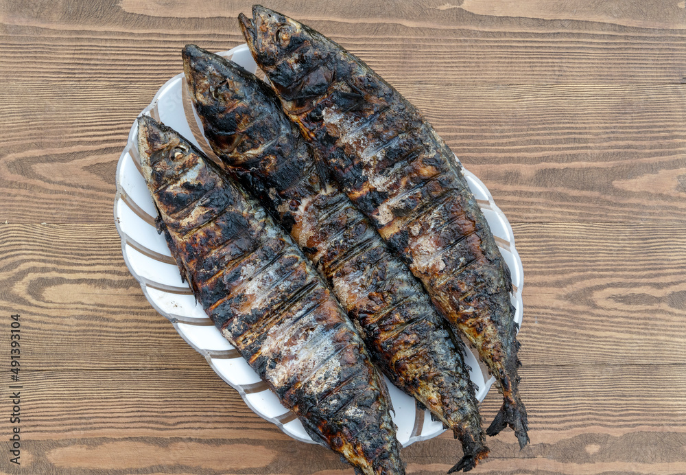 smoked fish on a wooden background smoked fish on a wooden background