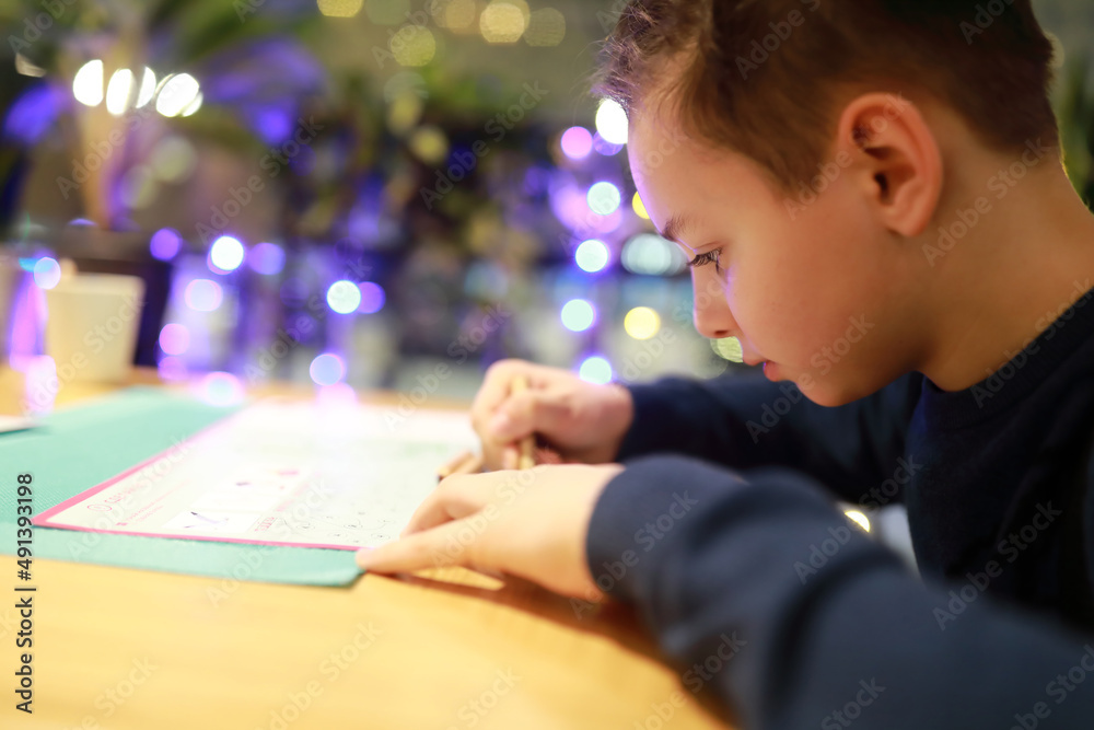 Child drawing in cafe