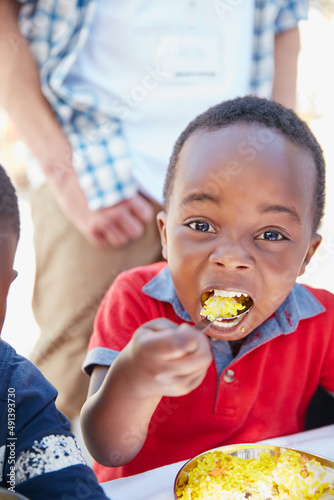 I love food. Cropped portrait of a young boy getting fed at a food outreach.