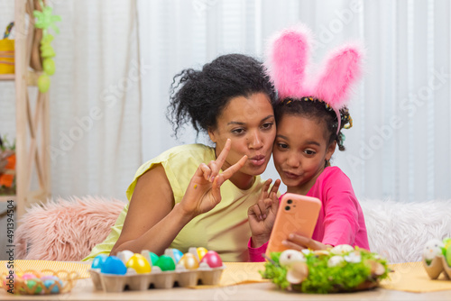 Canvas Print Mom and daughter with funny bunny ears take selfies and have fun
