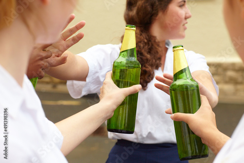 No. Young female student turning down alcohol in response to peer pressure.