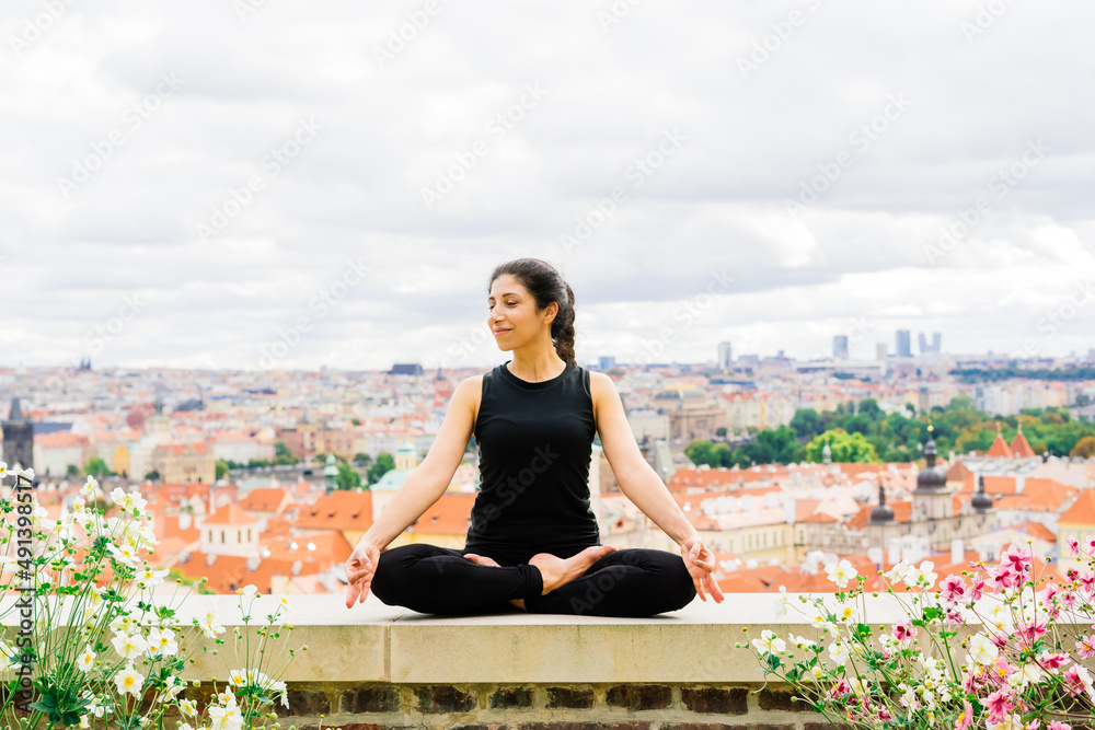 Healthy woman in sportswear practicing yoga outdoor, doing exercise, full length portrait.