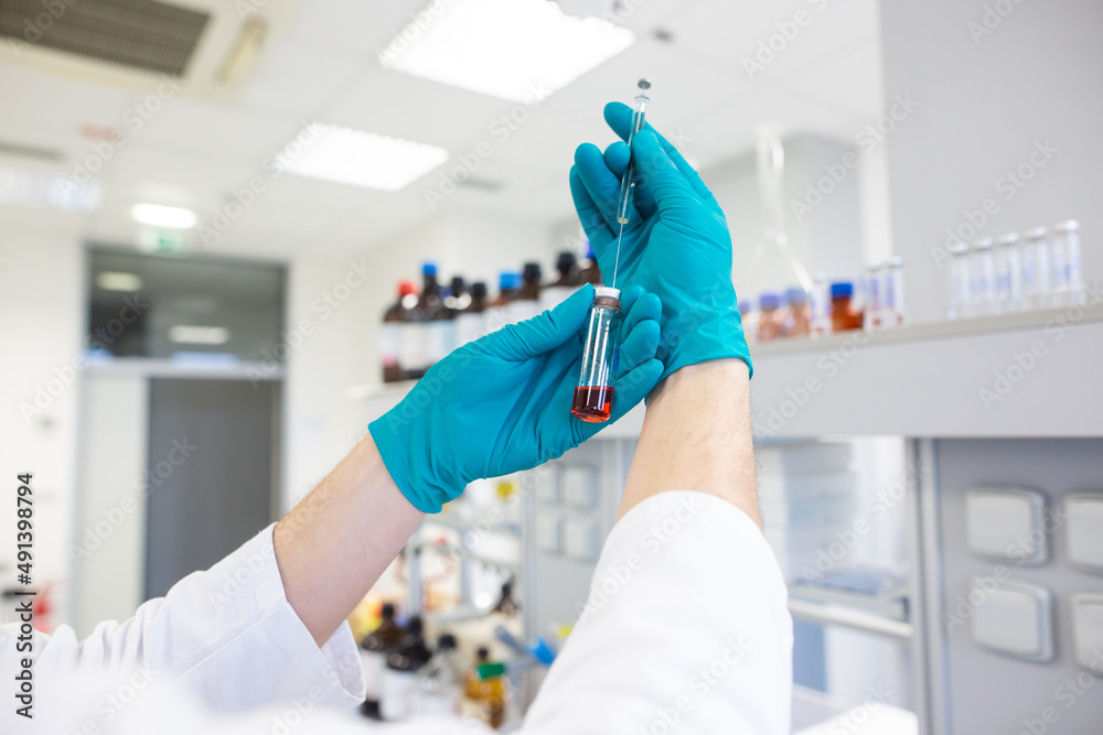 Researcher carrying out scientific research in a chemistry laboratory Researcher carrying out scientific research in a chemistry laboratory