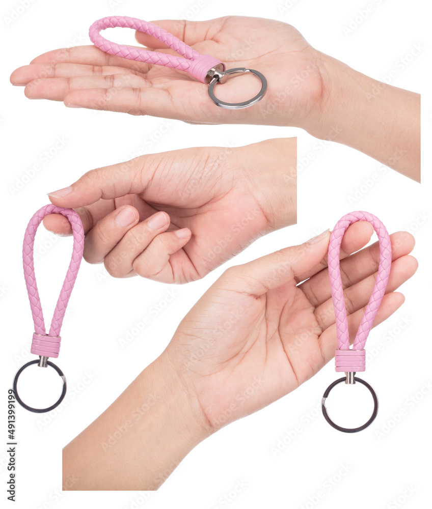 Set of hand holding Pink Leather Rope Keychain isolated on white background.