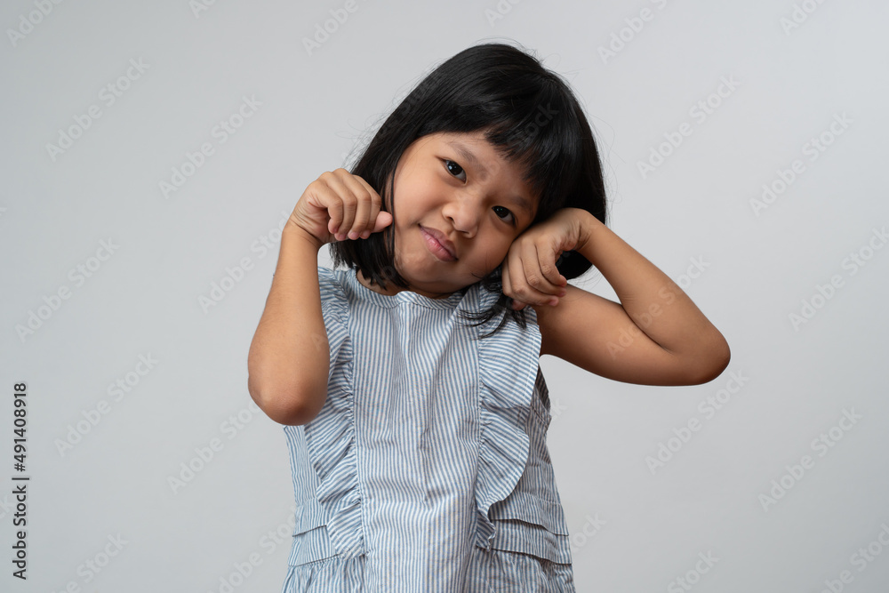 Portrait of happy and funny Asian child girl on white background, a child looking at camera hand gesture. Preschool kid dreaming fill with energy feeling healthy and good concept Portrait of happy and funny Asian child girl on white background, a child looking at camera hand gesture. Preschool kid dreaming fill with energy feeling healthy and good concept