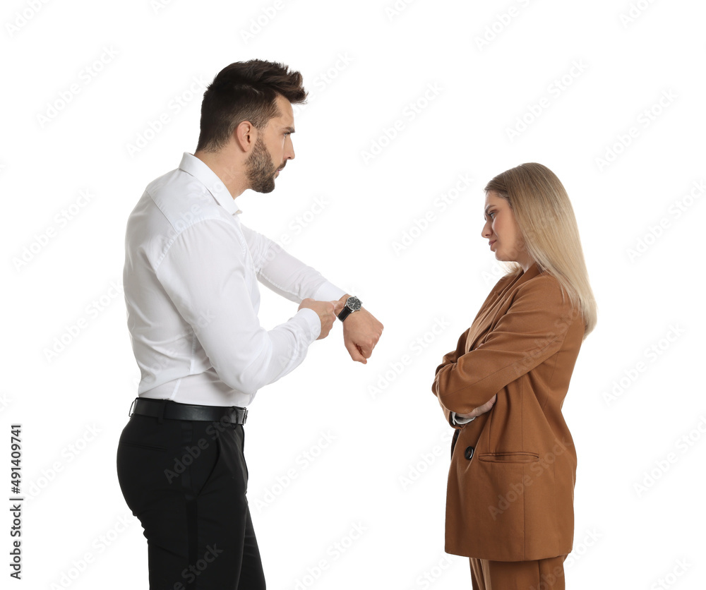 Businessman pointing on wrist watch while scolding employee for being late against white background Businessman pointing on wrist watch while scolding employee for being late against white background