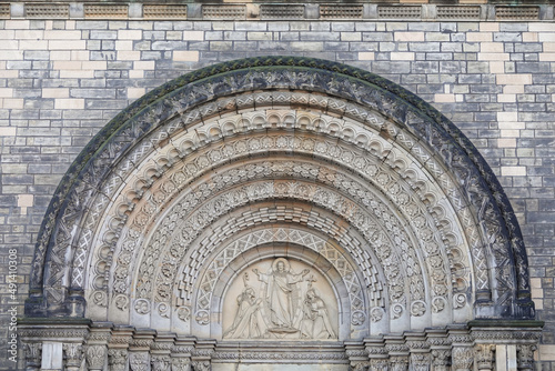 Jesus Christ blesses to Saint Cyril and Methodius. Neo-romanesque portal of Saint Cyril and Methodius Church in Karlin, Prague, Czech Republic. High quality photo