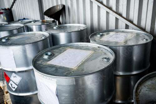 Big metal barrels containing hazardous chemicals from laboratories, waste management concept, industrial background, toxic chemicals