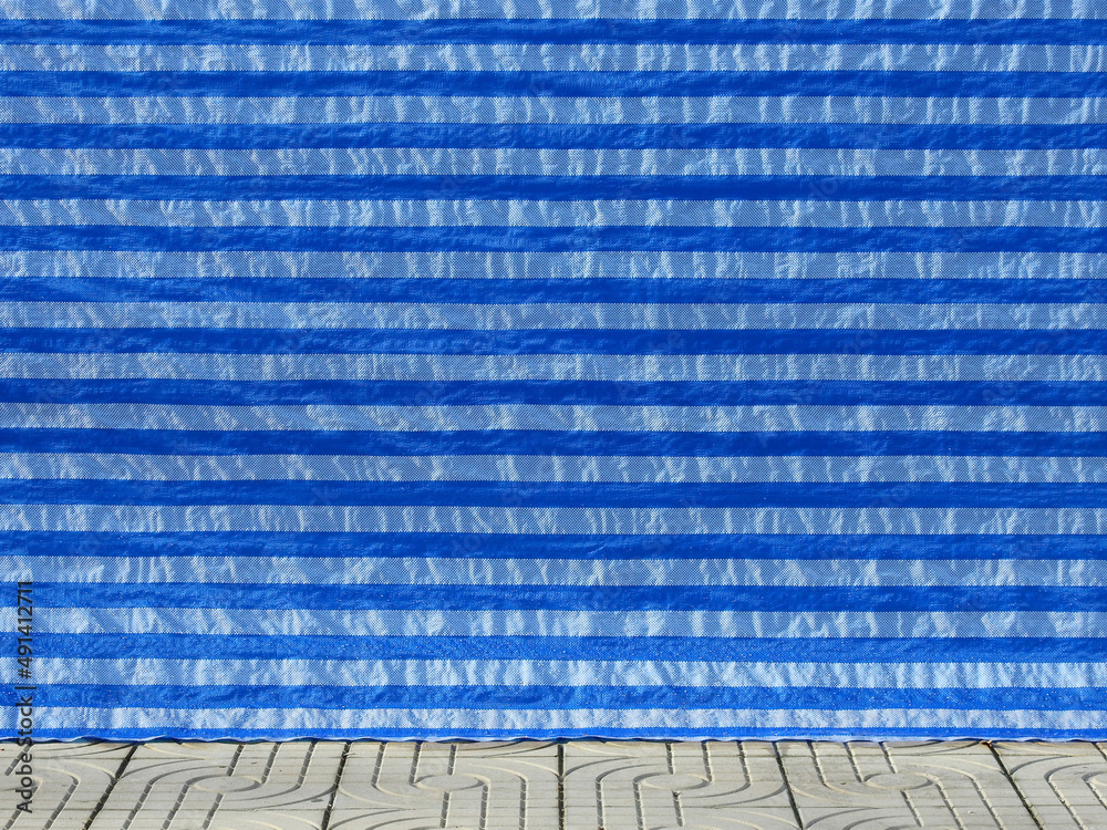 blue plastic canvas cover on street wall with floor in construction site